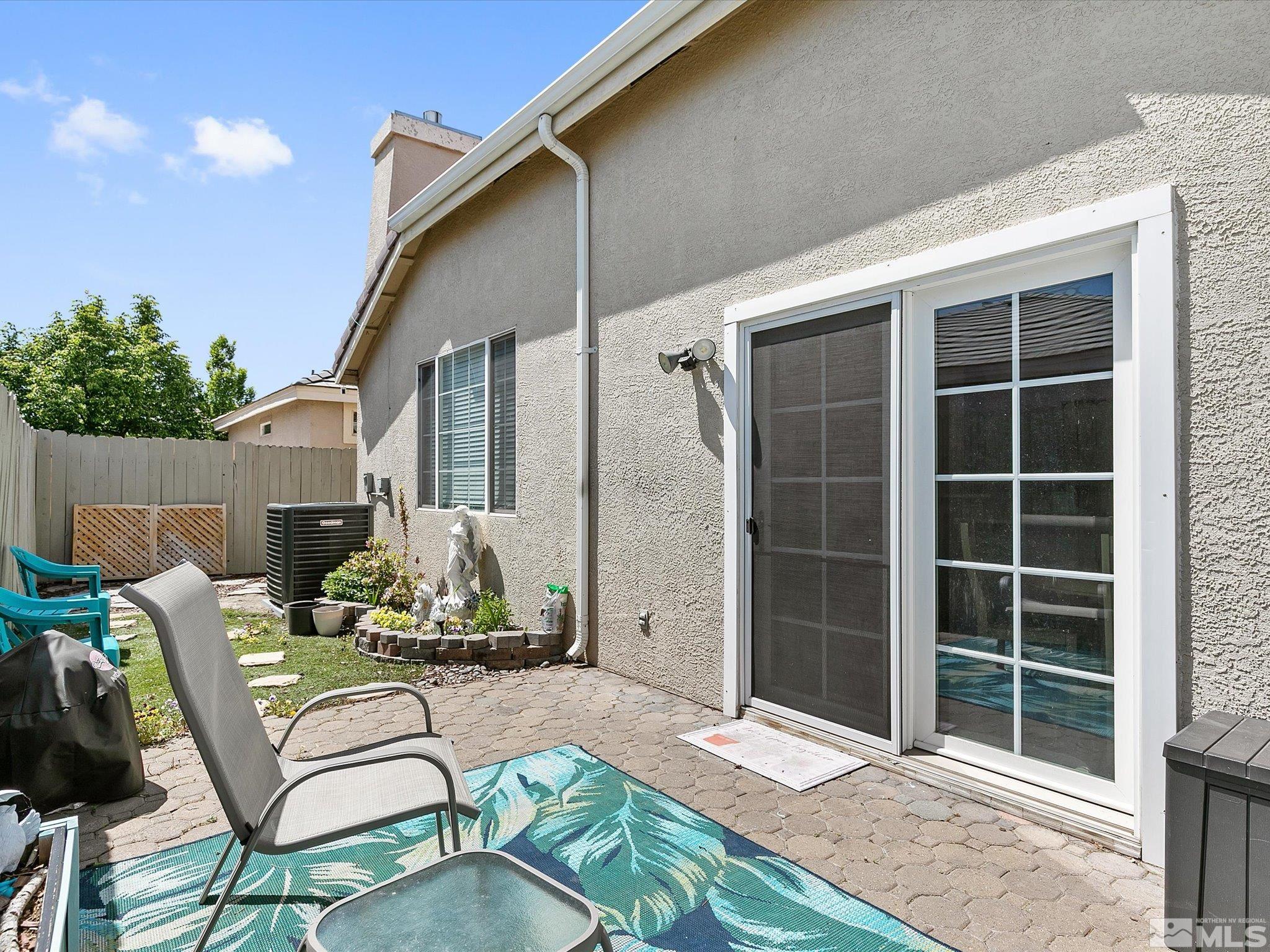 9740 Ripple Way Reno, NV 89521 - Photo 16 of 19 a view of a patio with table and chairs with wooden floor and fence