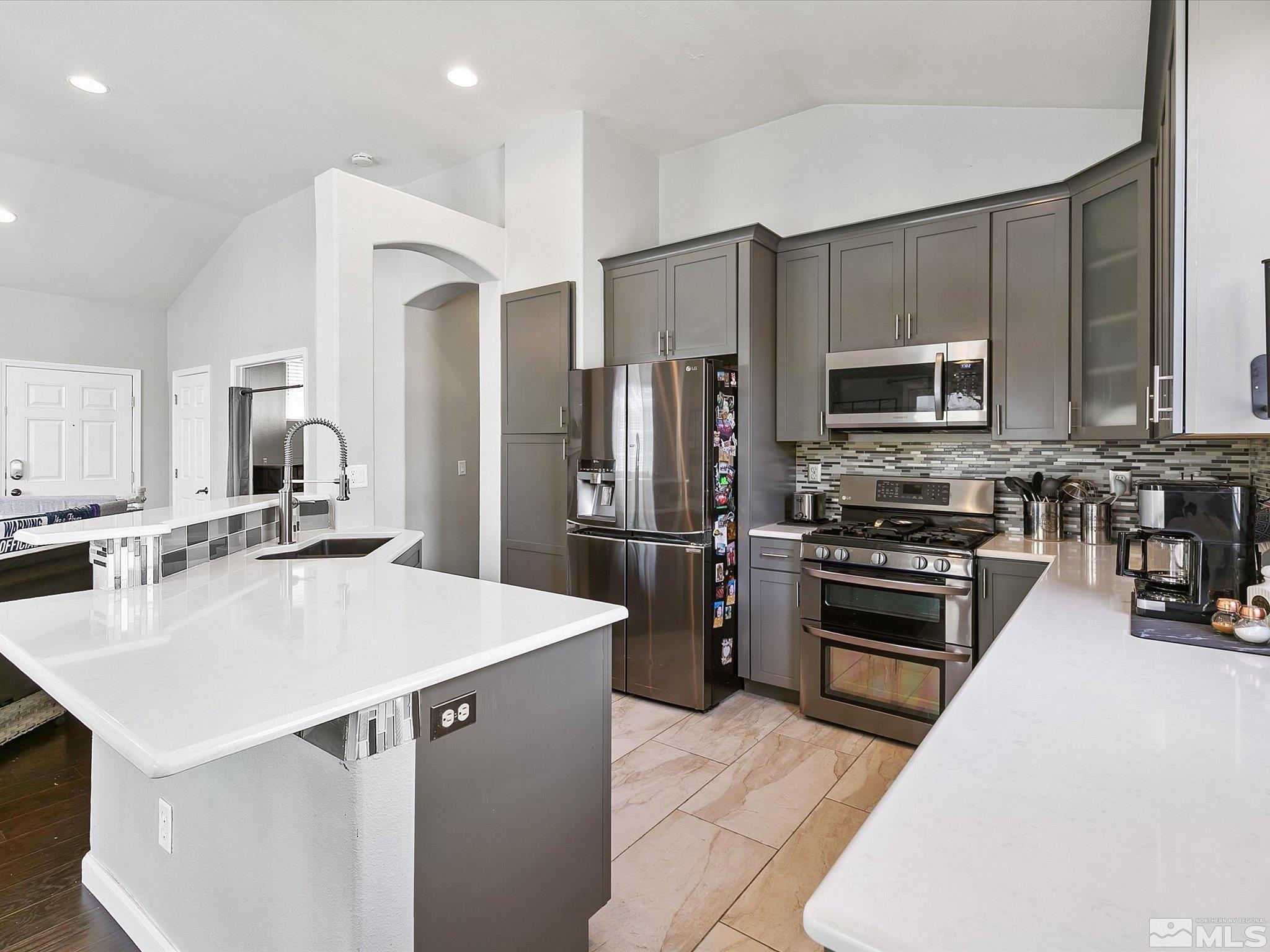 9740 Ripple Way Reno, NV 89521 - Photo 6 of 19 a kitchen with stainless steel appliances a refrigerator sink and stove