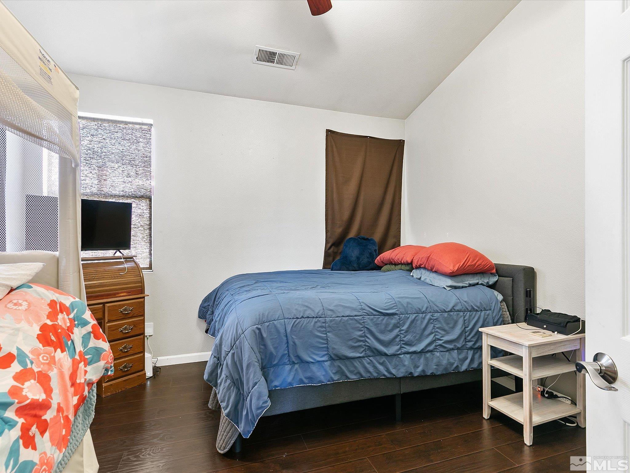 9740 Ripple Way Reno, NV 89521 - Photo 10 of 19 a bedroom with a bed and a flat screen tv