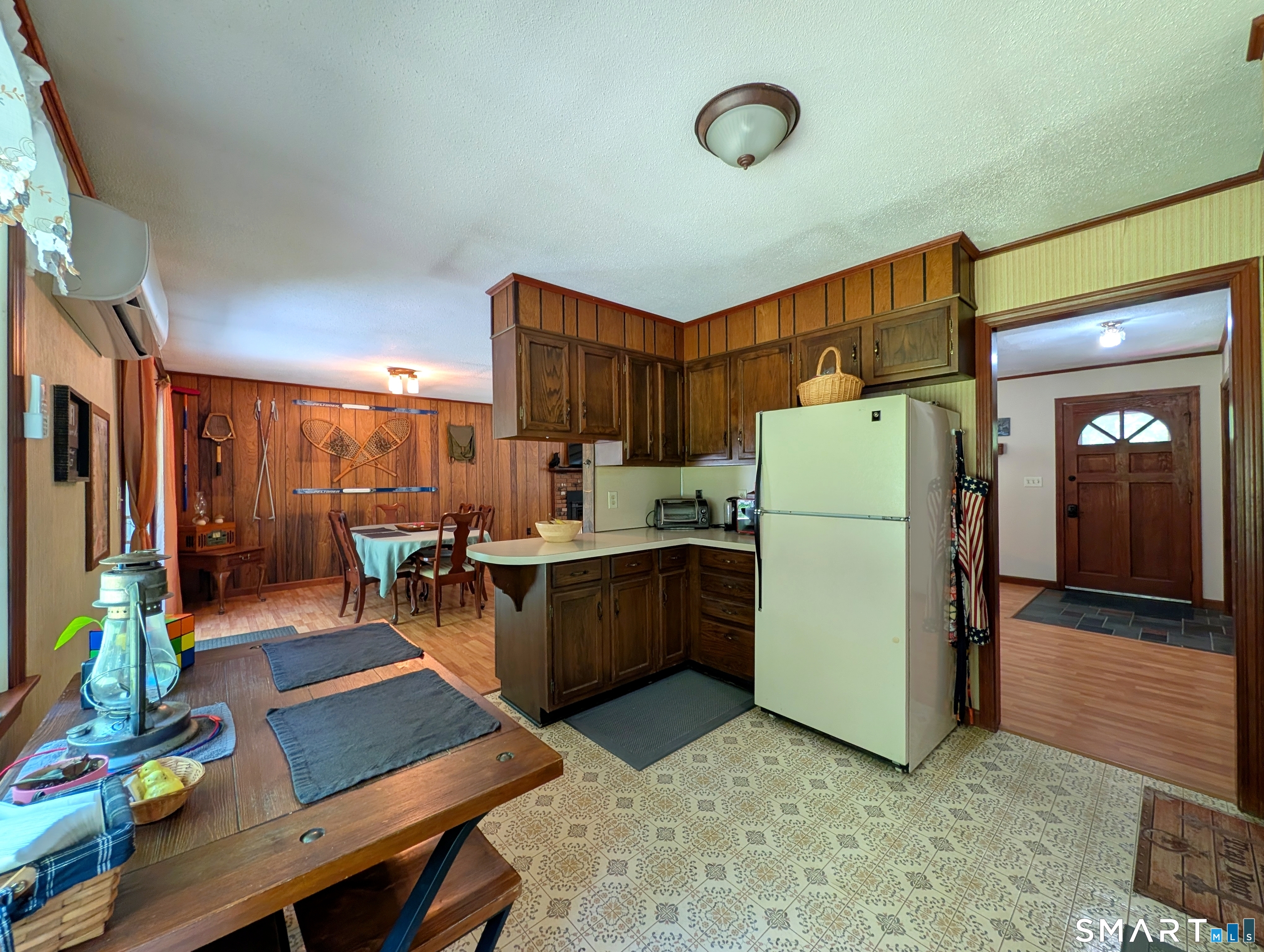 17 Colebrook Road Norfolk, CT 06058 - Photo 11 of 21 a kitchen with a refrigerator a stove top oven a sink and a dining table with wooden floor