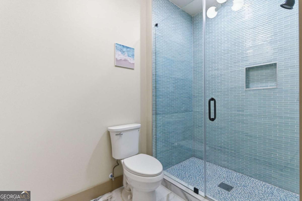 1315 Sandy Creek Road Tyrone, GA 30290 - Photo 90 of 100 a white toilet sitting next to a shower