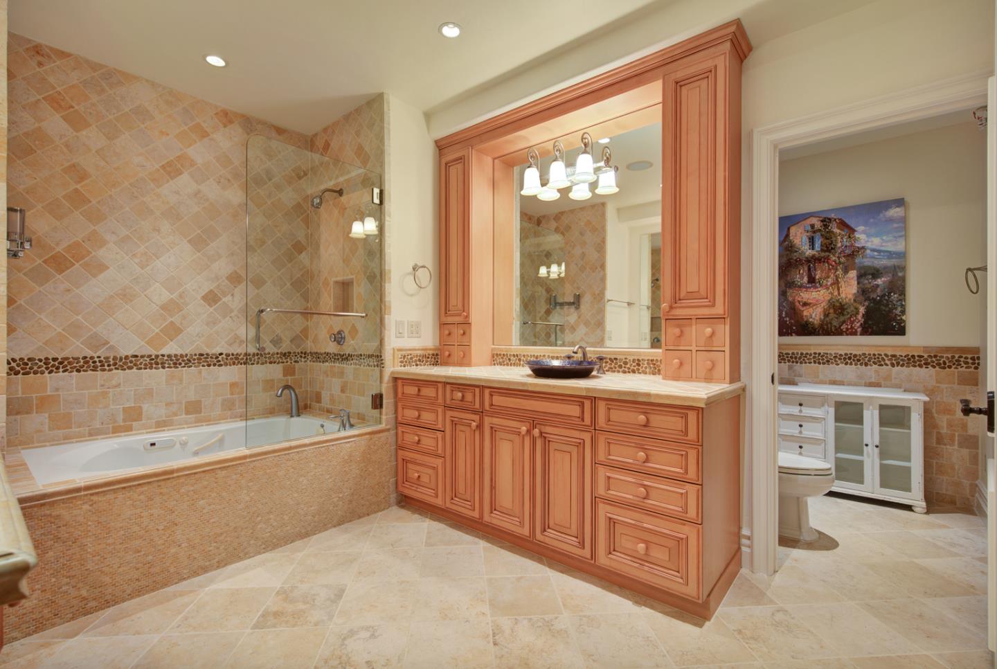 a spacious bathroom with a double vanity sink a mirror and a bathtub