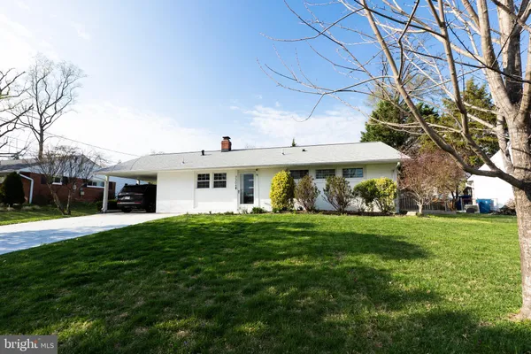 a front view of a house with a garden and yard