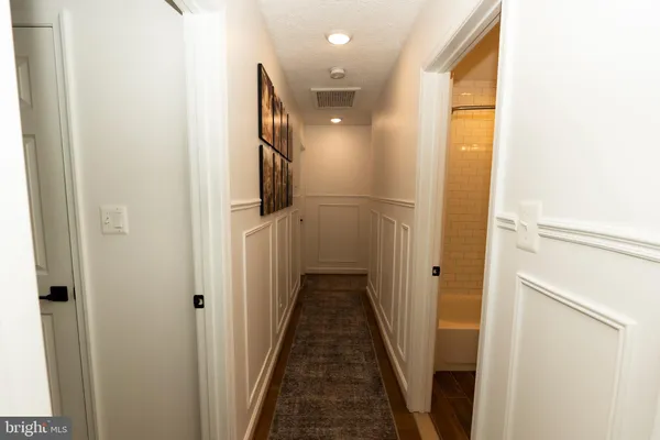a view of a hallway with wooden floor