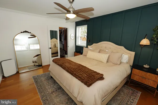a bedroom with a large bed and a chandelier