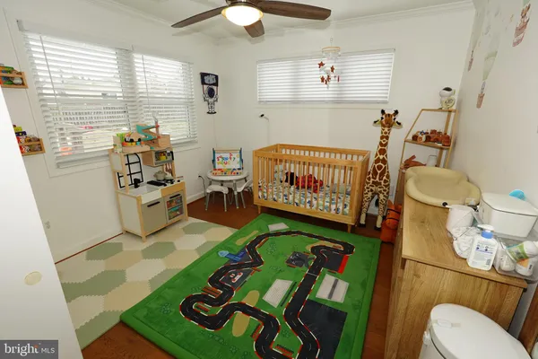 a bedroom with furniture and a large window