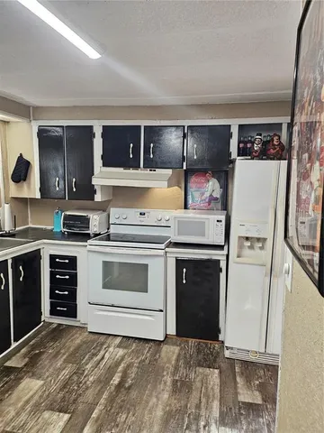 a kitchen with a stove and a refrigerator