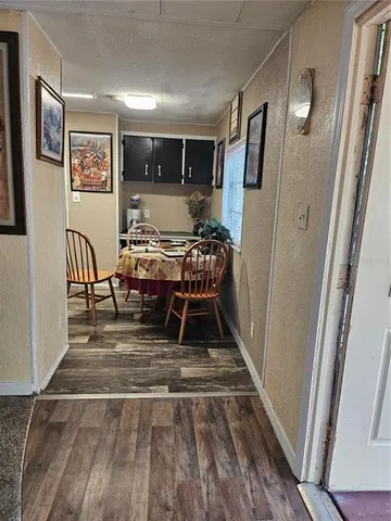 a view of a hallway with wooden floor and stairs