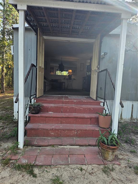 7657 North Caesar Point Dunnellon, FL 34433 - Photo 19 of 20 a view of staircase with wooden floor and a potted plant
