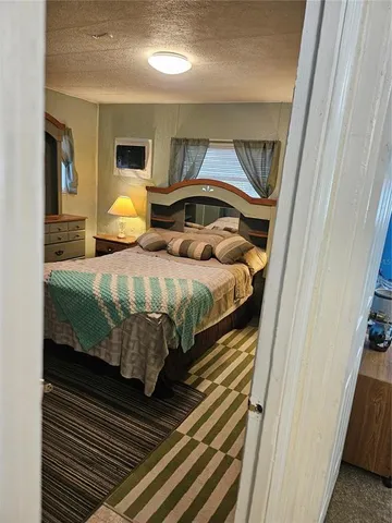 a bedroom with bed and wooden floor