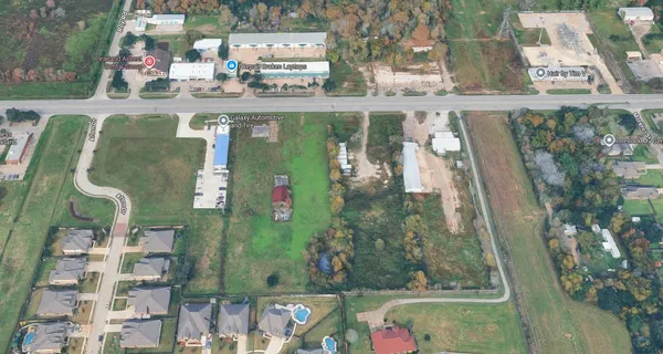an aerial view of a residential houses with outdoor space