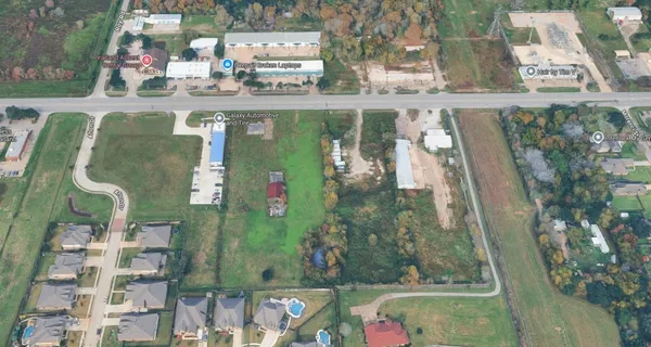 an aerial view of a residential houses with outdoor space