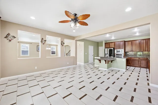 a kitchen with stainless steel appliances granite countertop a sink and a refrigerator