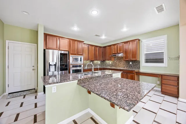 a kitchen with stainless steel appliances a stove and a refrigerator