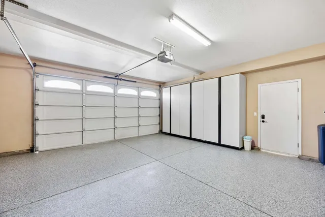 an empty room with wooden floor ceiling fan and windows
