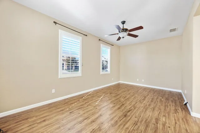 wooden floor in an empty room with a window