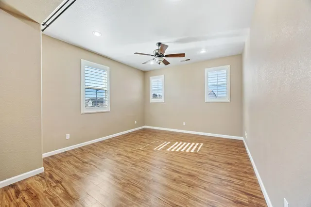 a white bath tub sitting in a bedroom next to a window