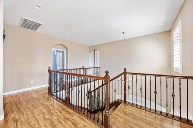 a view of an empty room with cabinet and a window