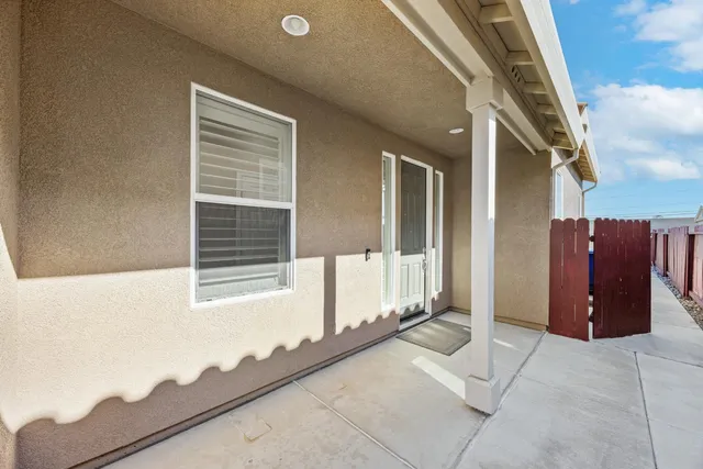 a view of a patio with couches near an ocean