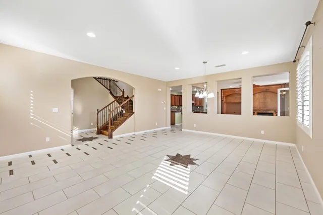 a large kitchen with stainless steel appliances kitchen island a chandelier