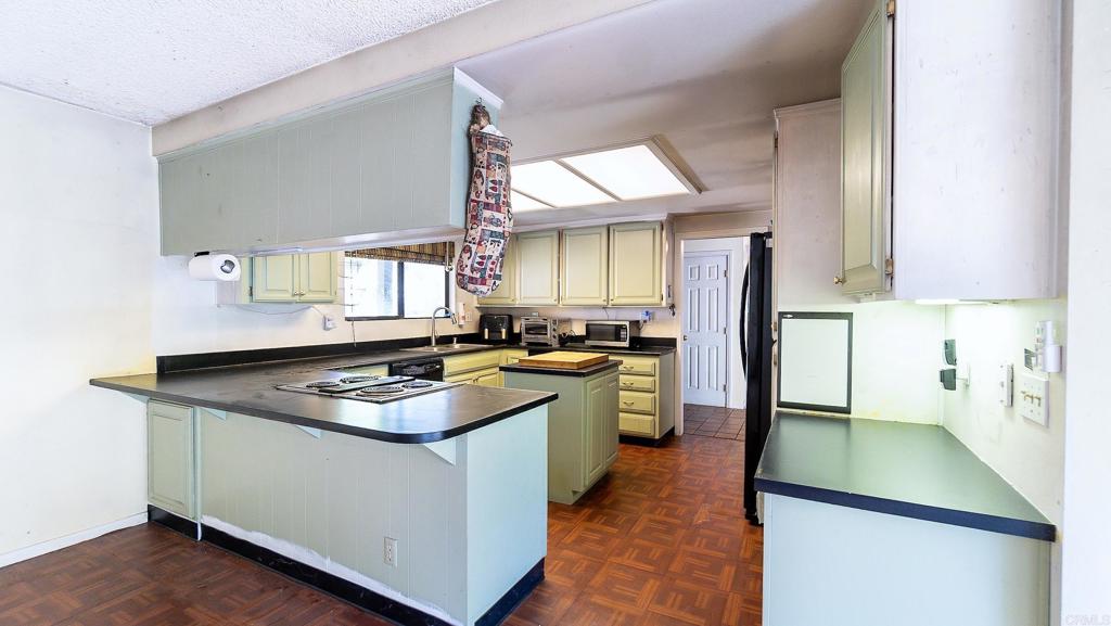 1002 Summer Glen Road Ramona, CA 92065 - Photo 17 of 40 a kitchen with stainless steel appliances granite countertop a sink stove and refrigerator