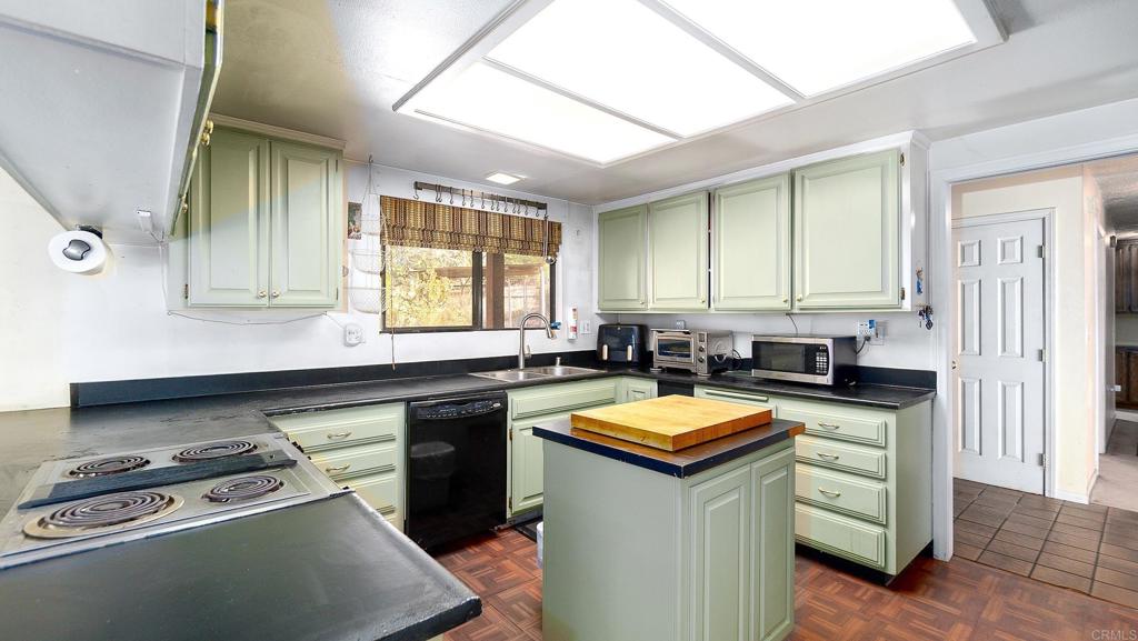 1002 Summer Glen Road Ramona, CA 92065 - Photo 18 of 40 a kitchen with stainless steel appliances granite countertop a stove a sink dishwasher and a refrigerator