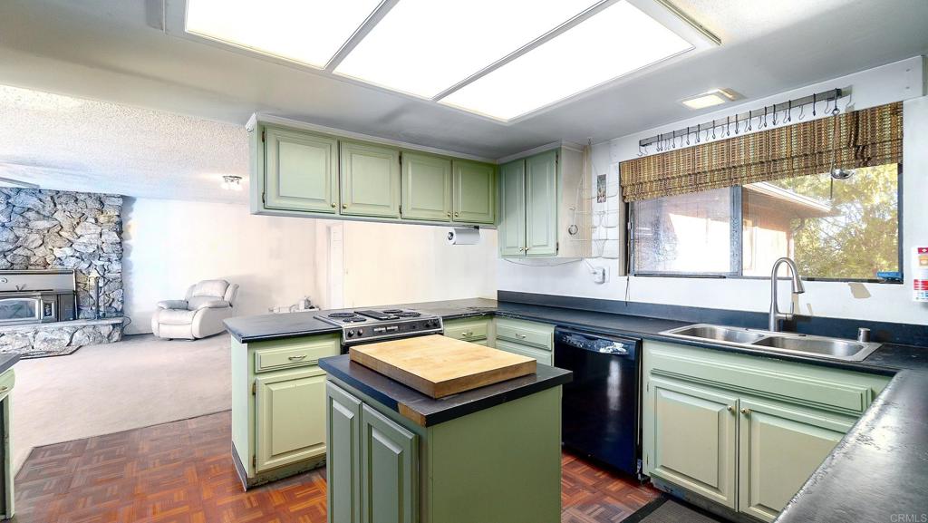 1002 Summer Glen Road Ramona, CA 92065 - Photo 19 of 40 a kitchen with a sink and a stove top oven
