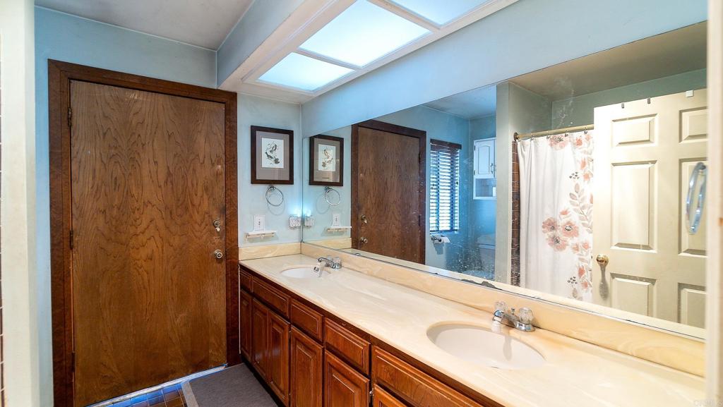 1002 Summer Glen Road Ramona, CA 92065 - Photo 24 of 40 a bathroom with a double vanity sink and mirror