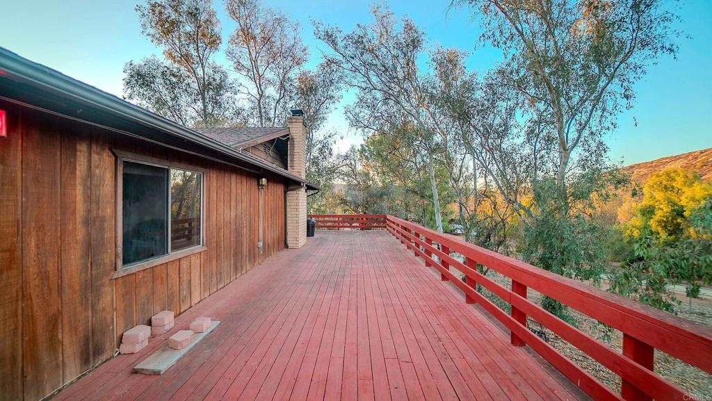 1002 Summer Glen Road Ramona, CA 92065 - Photo 9 of 40 a balcony with wooden floor and trees in the back