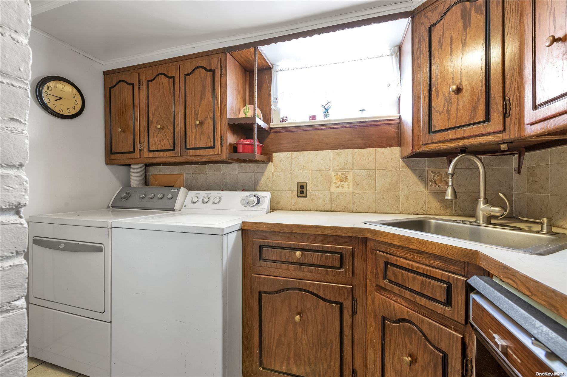 166-40 15th Drive Queens, NY 11357 - Photo 13 of 28 a view of a sink and a refrigerator a mirror