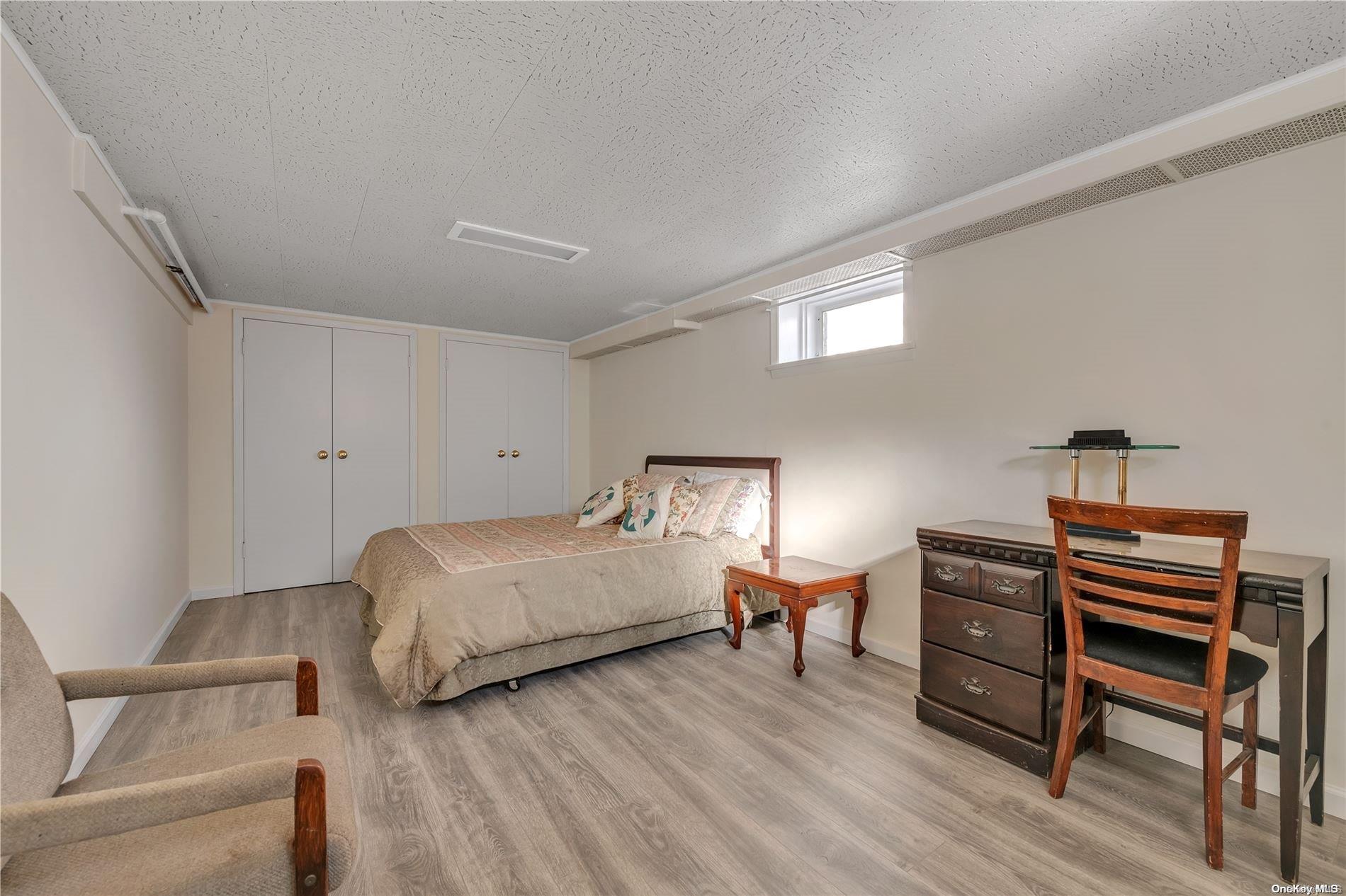 166-40 15th Drive Queens, NY 11357 - Photo 15 of 28 a bedroom with a bed and a closet