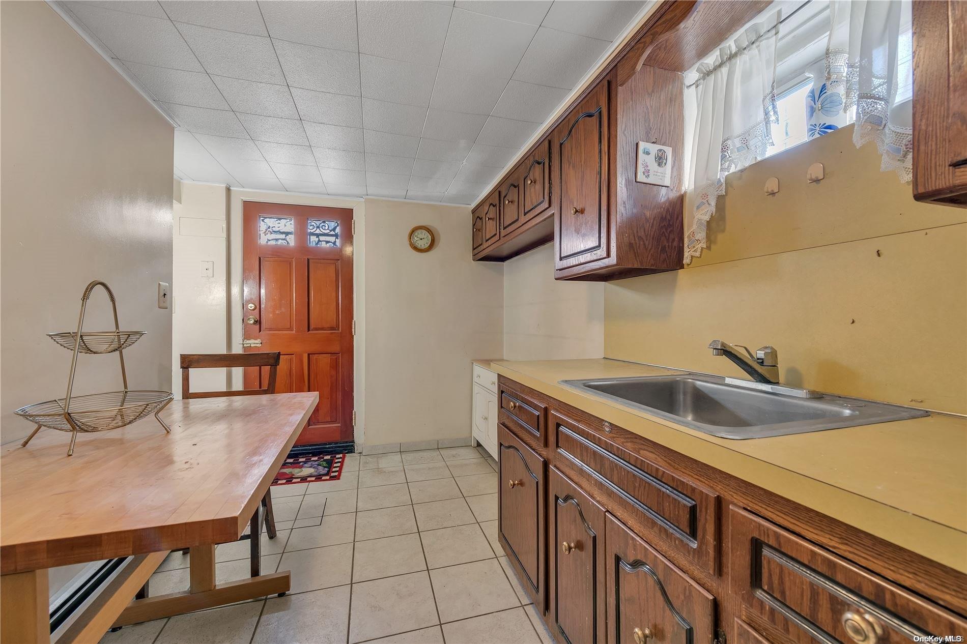 166-40 15th Drive Queens, NY 11357 - Photo 17 of 28 a kitchen with a sink and cabinets