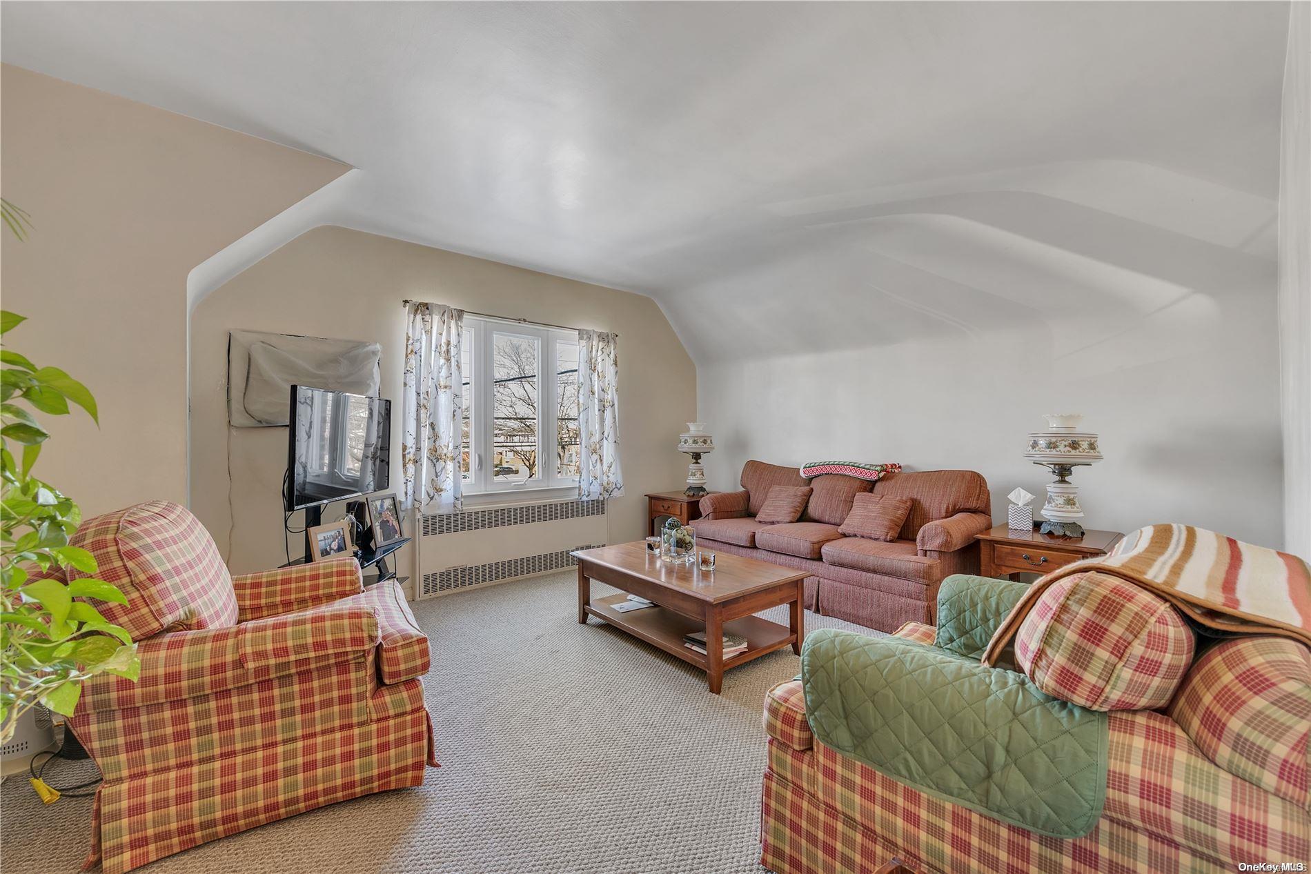 166-40 15th Drive Queens, NY 11357 - Photo 18 of 28 a living room with furniture and a large window