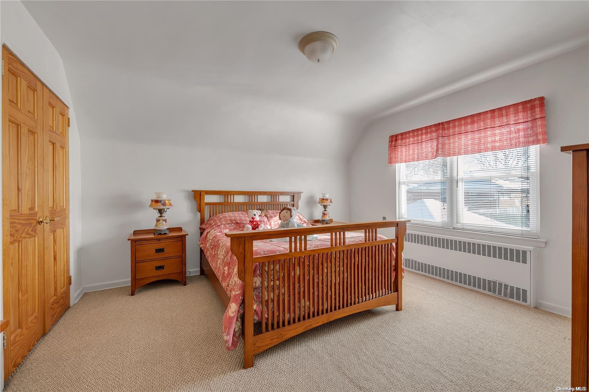 166-40 15th Drive Queens, NY 11357 - Photo 22 of 28 a view of a bedroom with furniture and windows