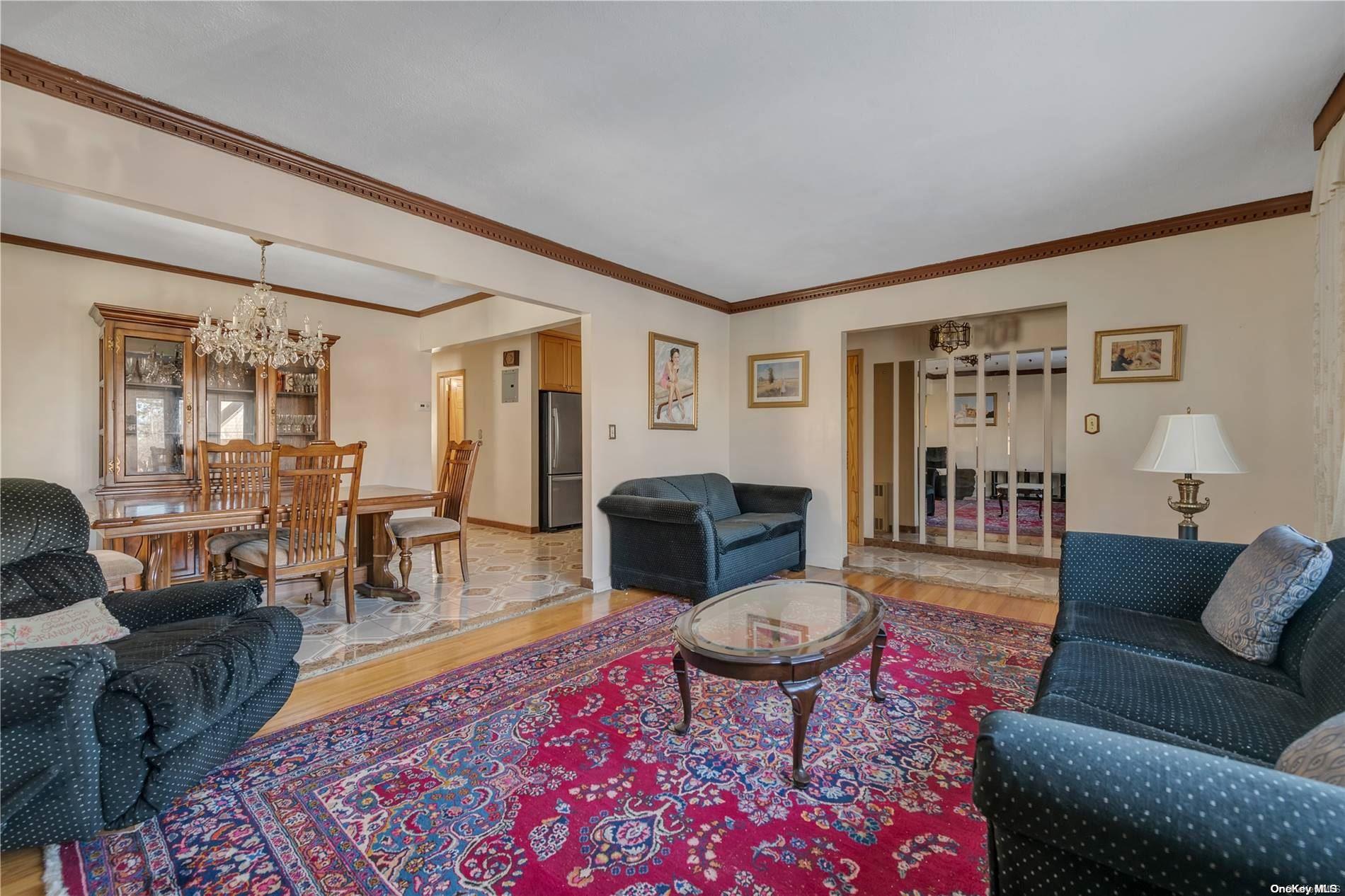 166-40 15th Drive Queens, NY 11357 - Photo 3 of 28 a living room with furniture a rug and a table