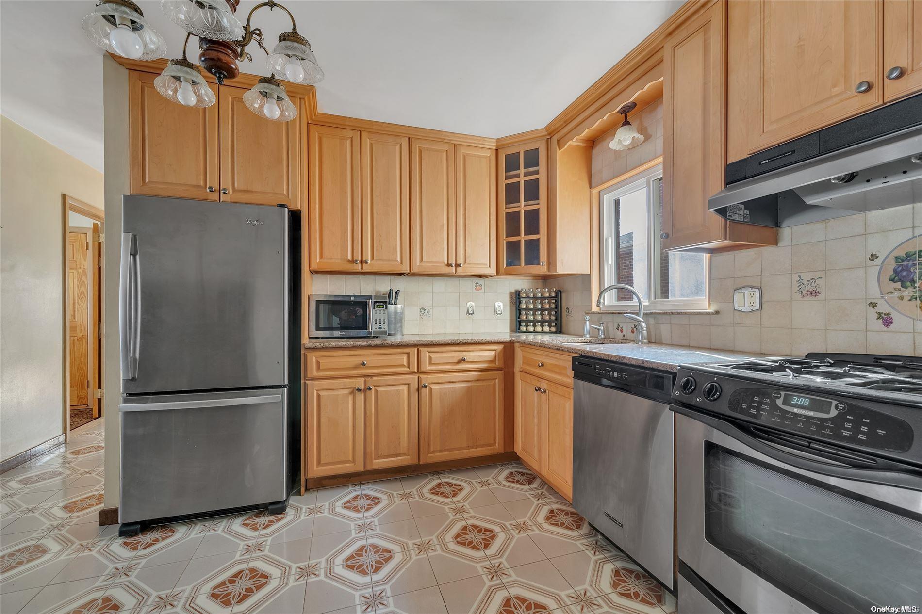 166-40 15th Drive Queens, NY 11357 - Photo 5 of 28 a kitchen with stainless steel appliances granite countertop a refrigerator sink and stove
