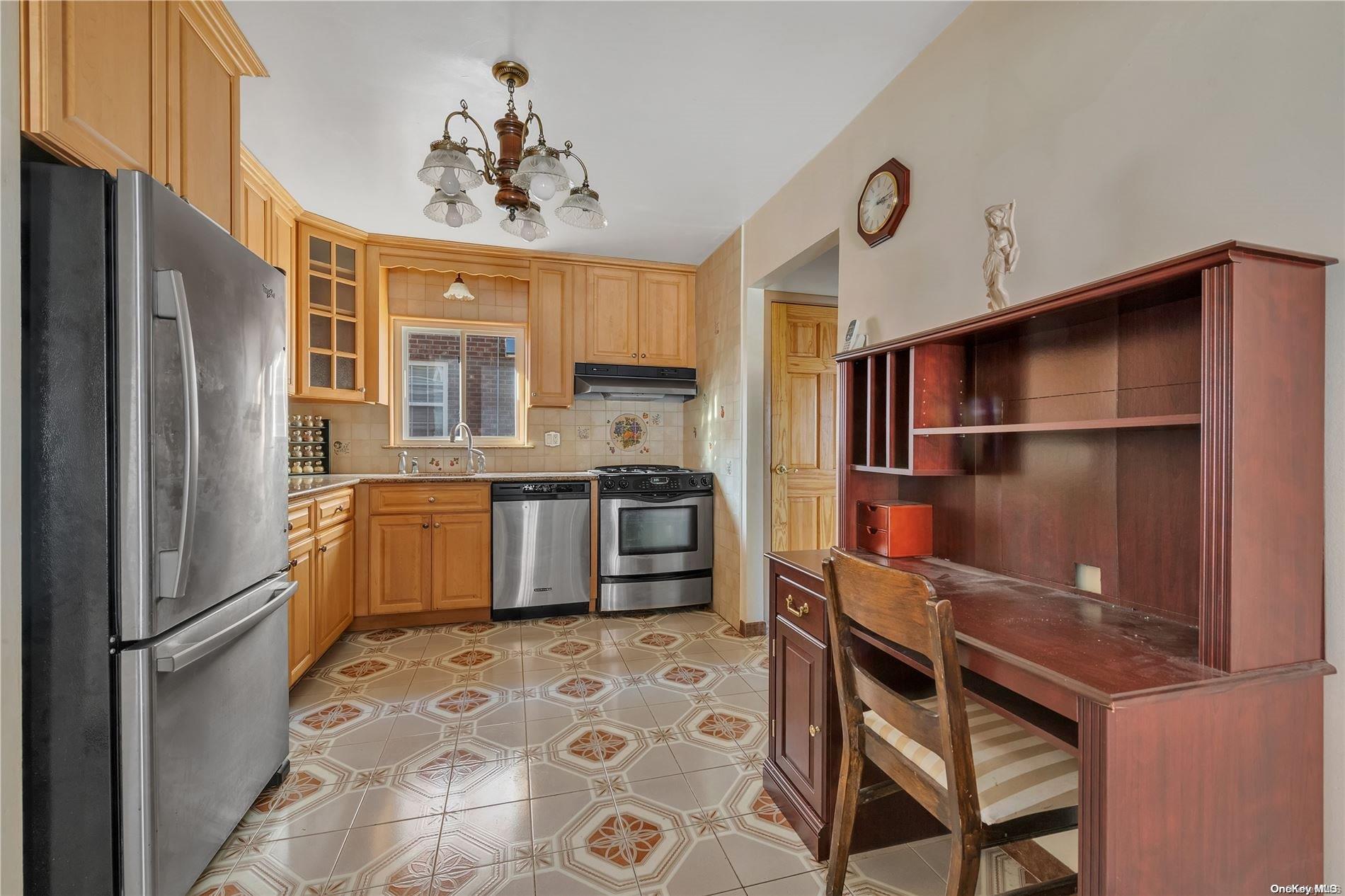 166-40 15th Drive Queens, NY 11357 - Photo 6 of 28 a kitchen with stainless steel appliances a refrigerator sink and cabinets