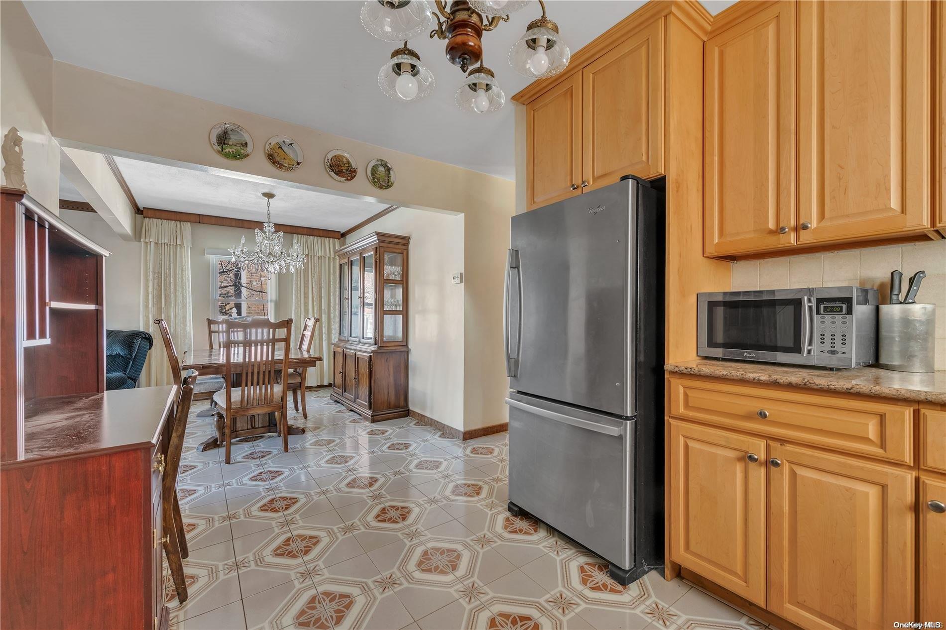 166-40 15th Drive Queens, NY 11357 - Photo 7 of 28 a kitchen with stainless steel appliances granite countertop a refrigerator and microwave