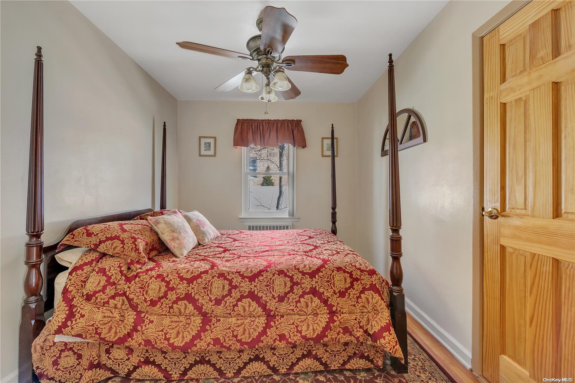 166-40 15th Drive Queens, NY 11357 - Photo 10 of 28 a bedroom with a bed and a chandelier