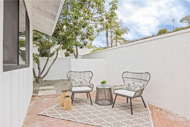 a view of a chairs and table in the balcony
