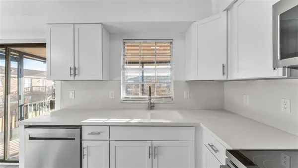 a kitchen with a sink cabinets and window