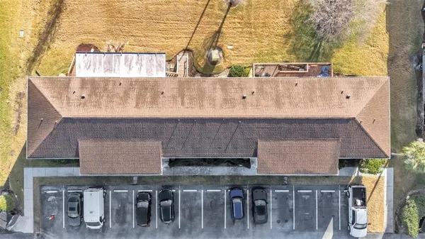 an aerial view of a house with table and chairs