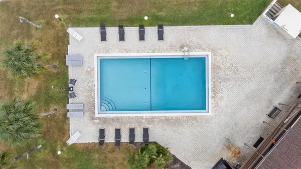a view of a swimming pool with a yard and lake view