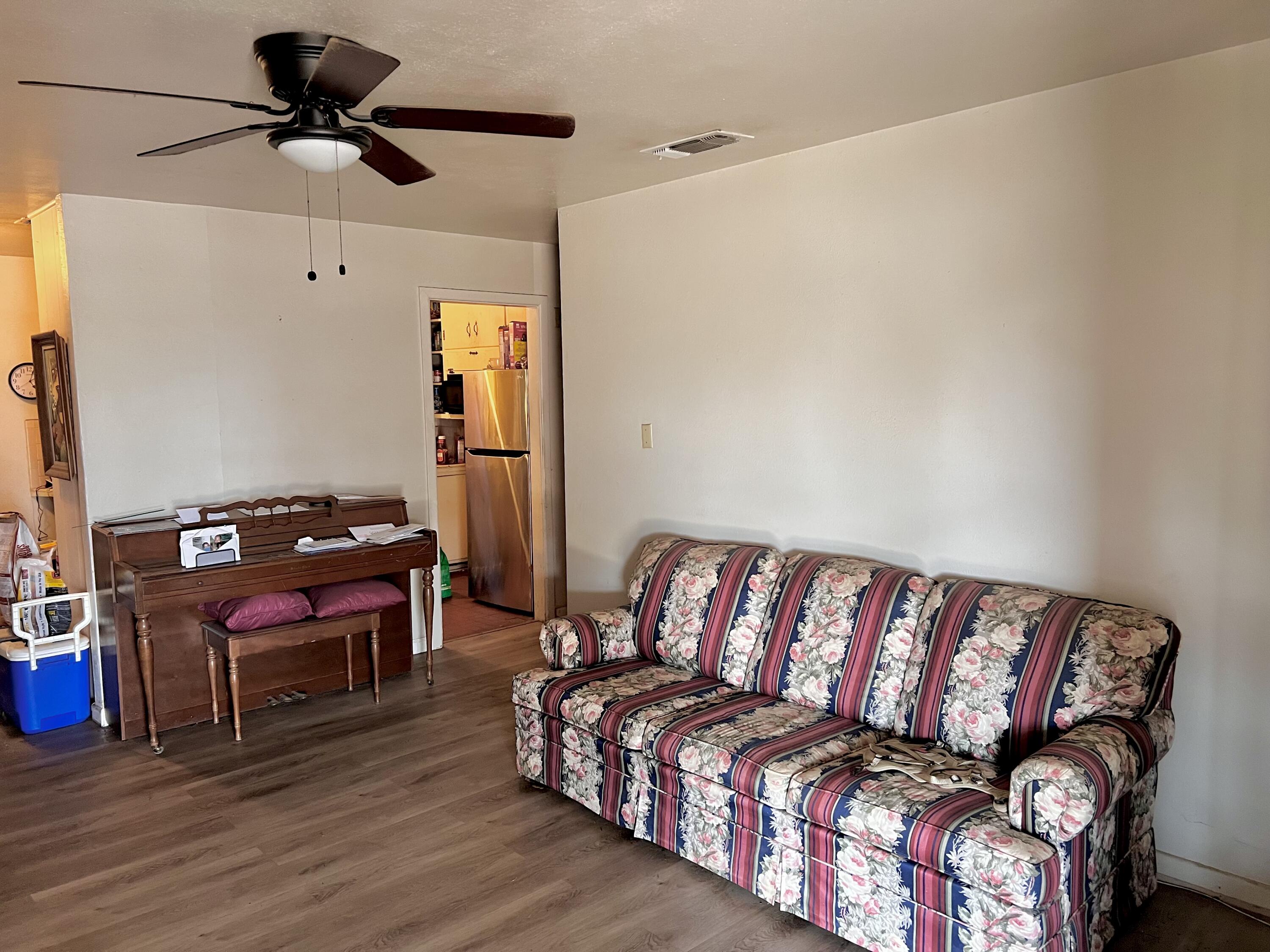 1801 East 2nd Street Lubbock, TX 79403 - Photo 3 of 7 a bedroom with a bed and wooden floor