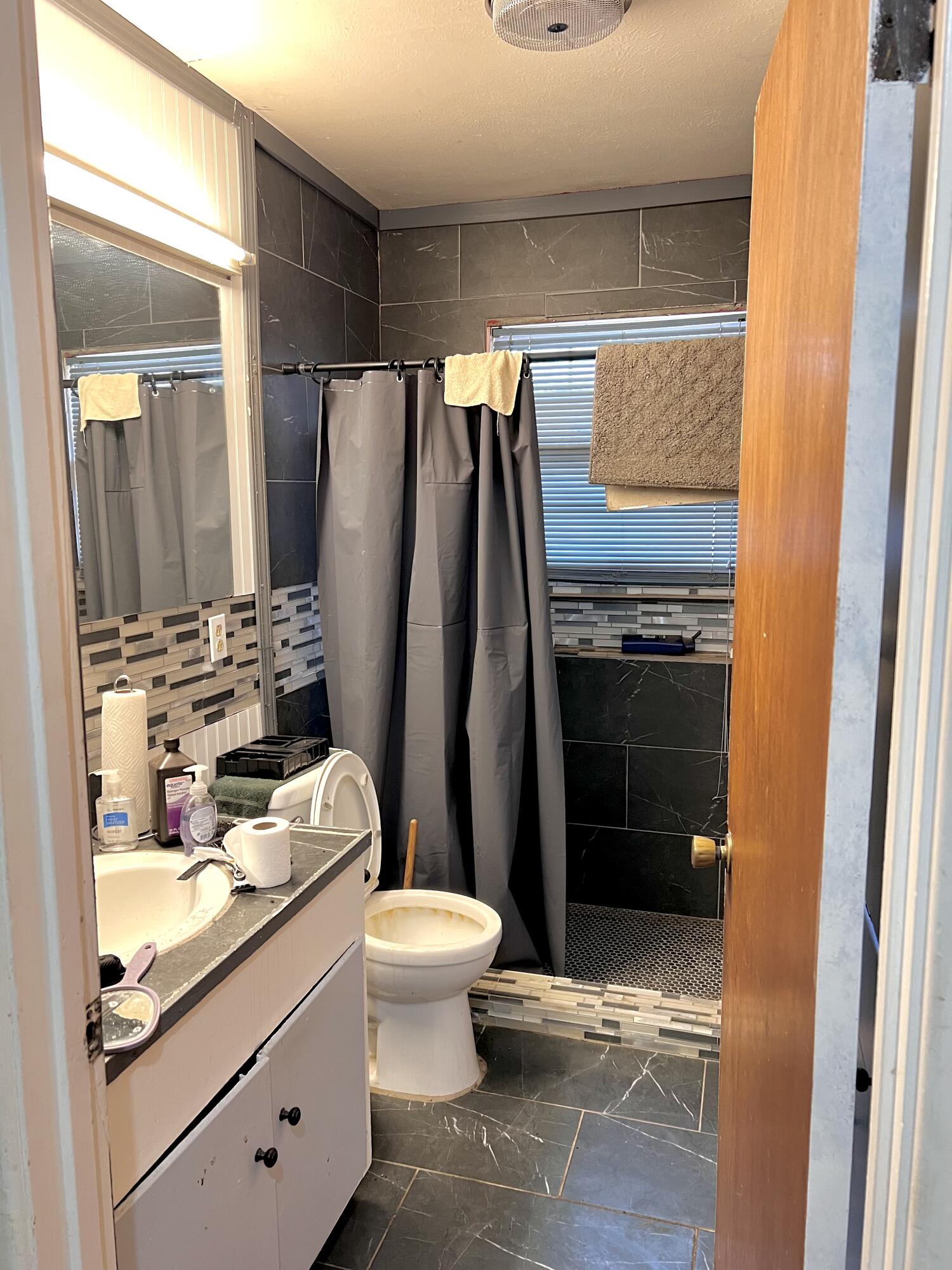 1801 East 2nd Street Lubbock, TX 79403 - Photo 7 of 7 a bathroom with a sink and a mirror