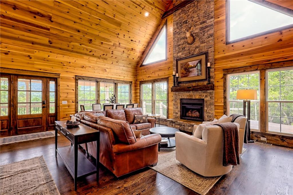 63 Redwood Lane Tiger, GA 30576 - Photo 16 of 77 a living room with furniture a fireplace and wooden floor