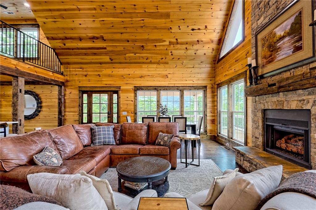 63 Redwood Lane Tiger, GA 30576 - Photo 17 of 77 a living room with furniture a fireplace and a large window