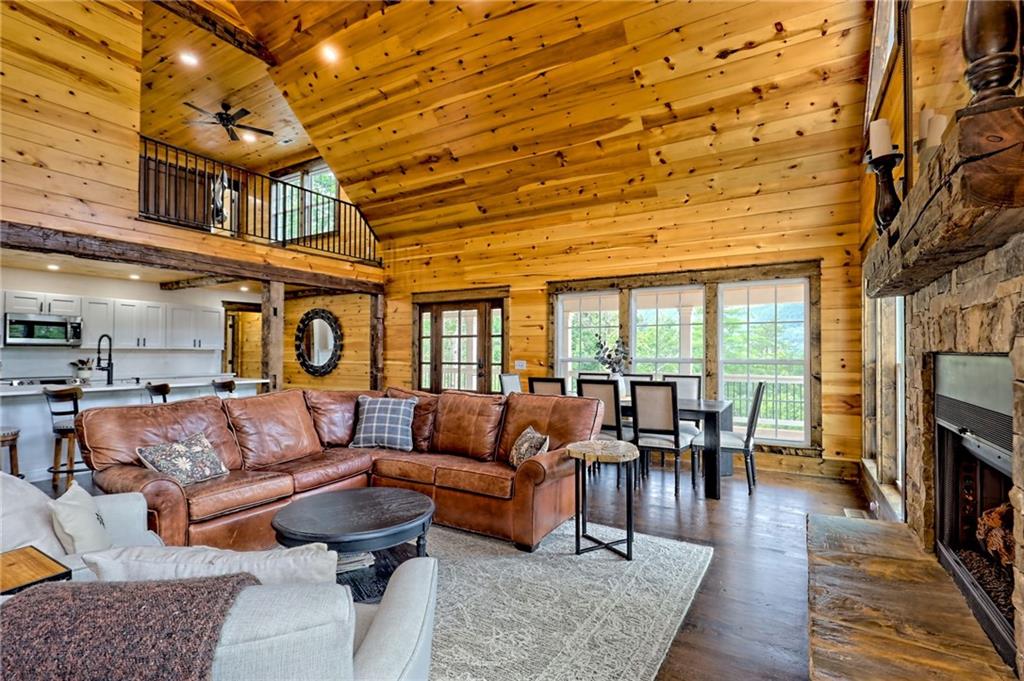 63 Redwood Lane Tiger, GA 30576 - Photo 18 of 77 a living room with furniture a fireplace and wooden floor
