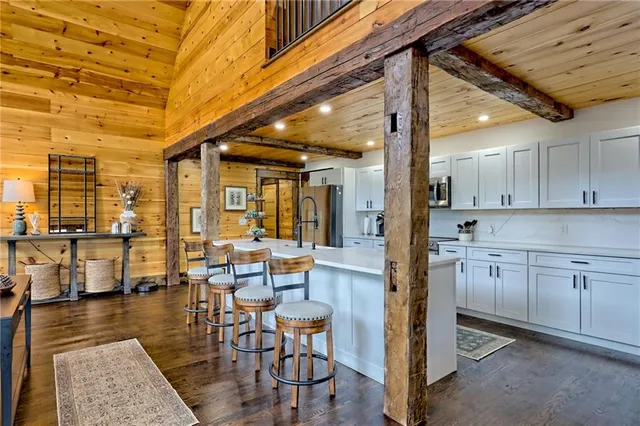 a spacious bathroom with a granite countertop sink toilet a mirror and shower
