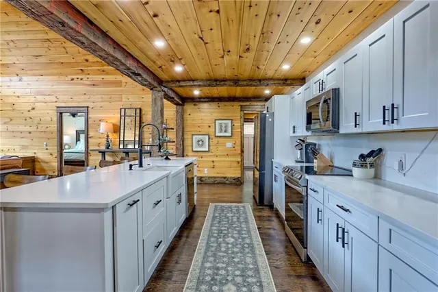 a white bath tub sitting in a bathroom next to a window